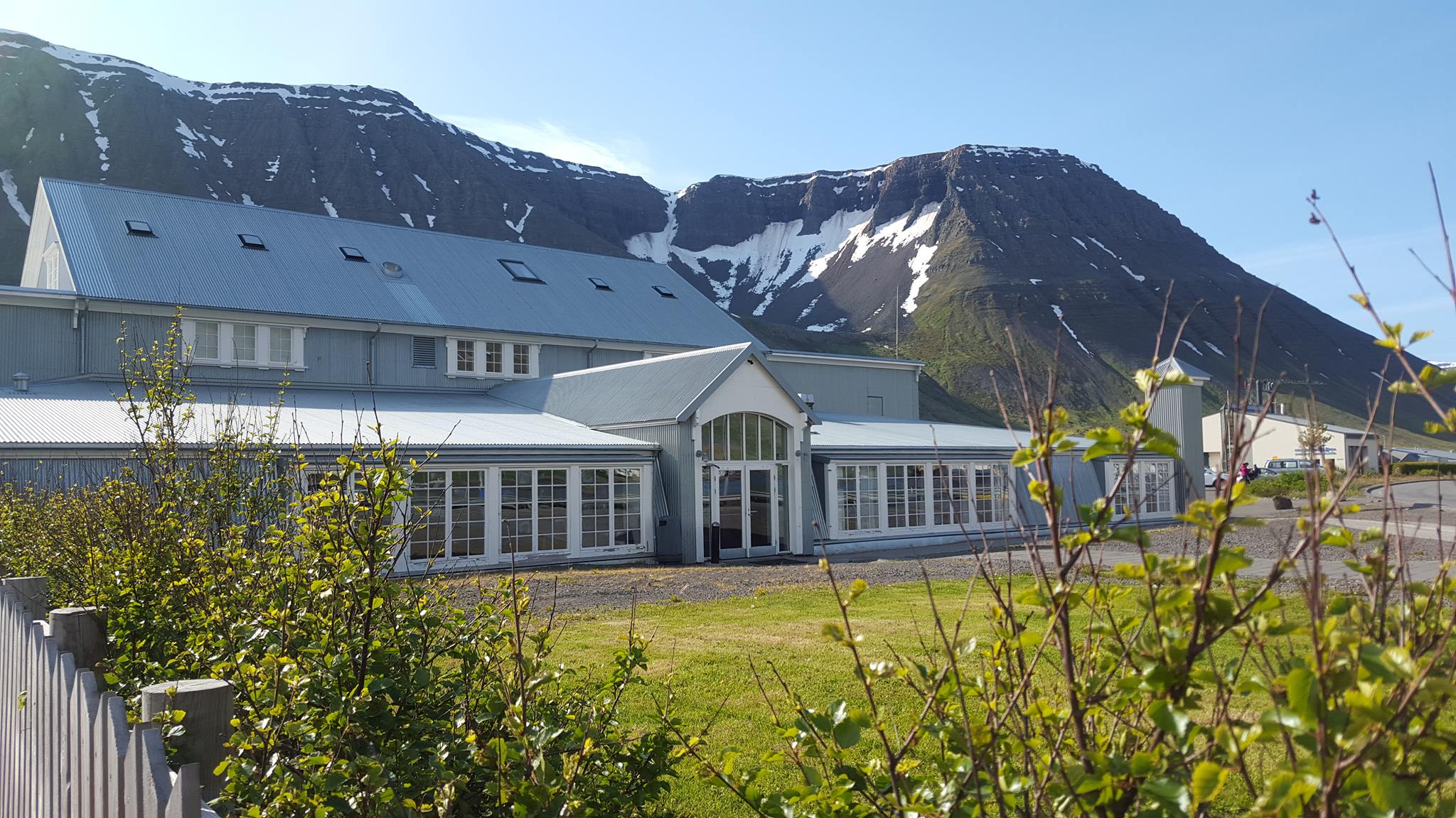 Iceland Cinema building in Ísafjörður with dramatic mountains behind