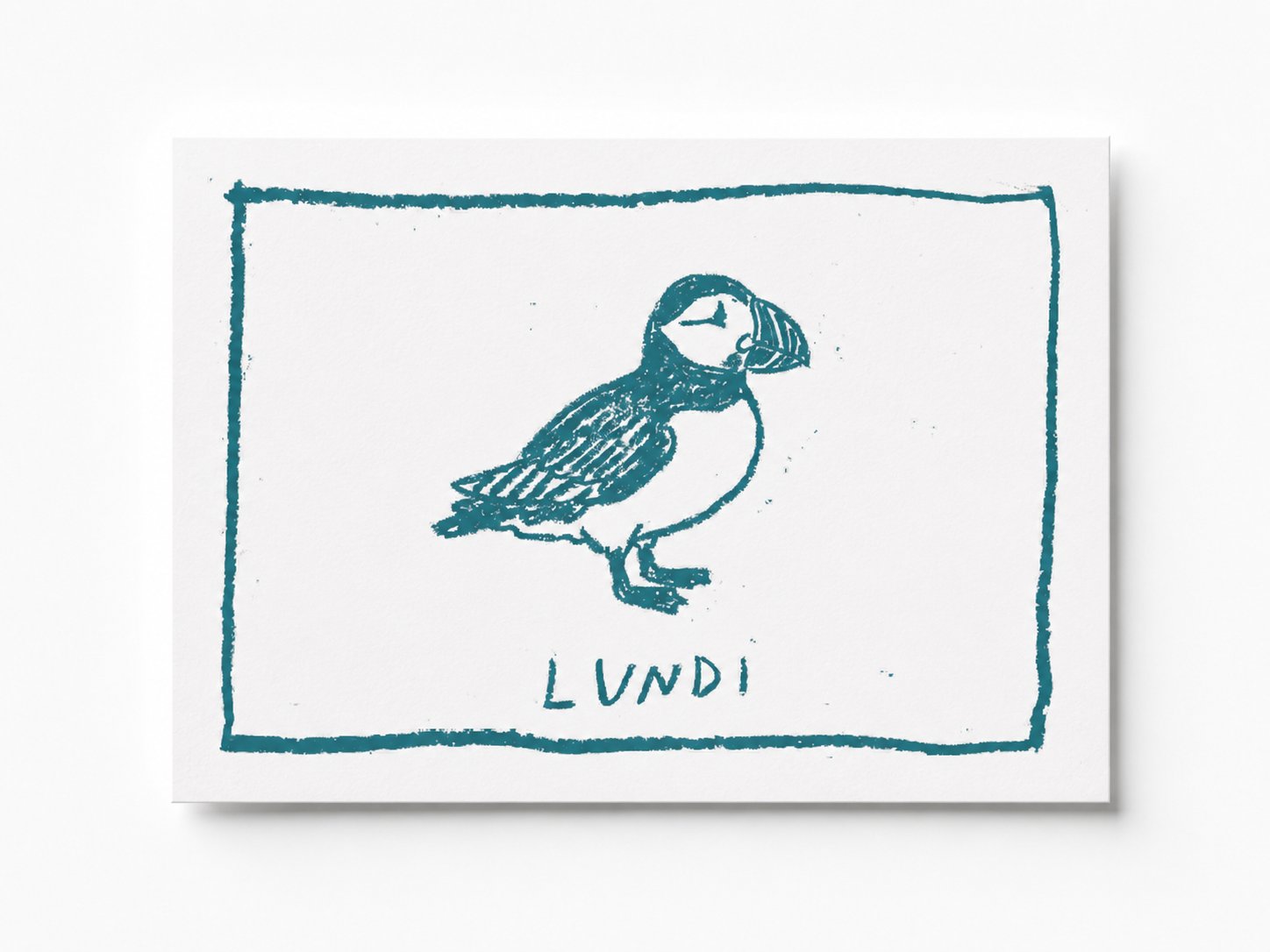 Lundi — puffin lino-print postcard in teal